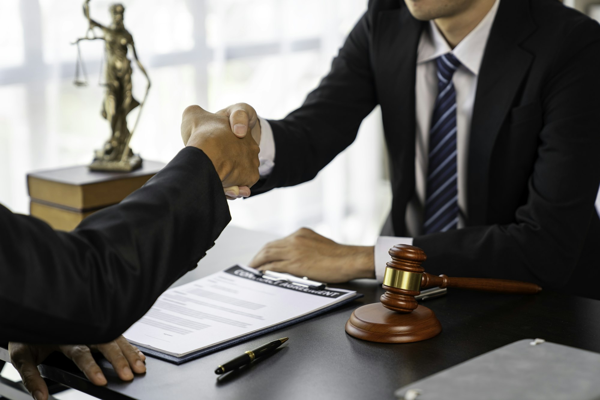 Lawyers shake hands with business people to seal a deal with partner lawyers. or a lawyer discussing